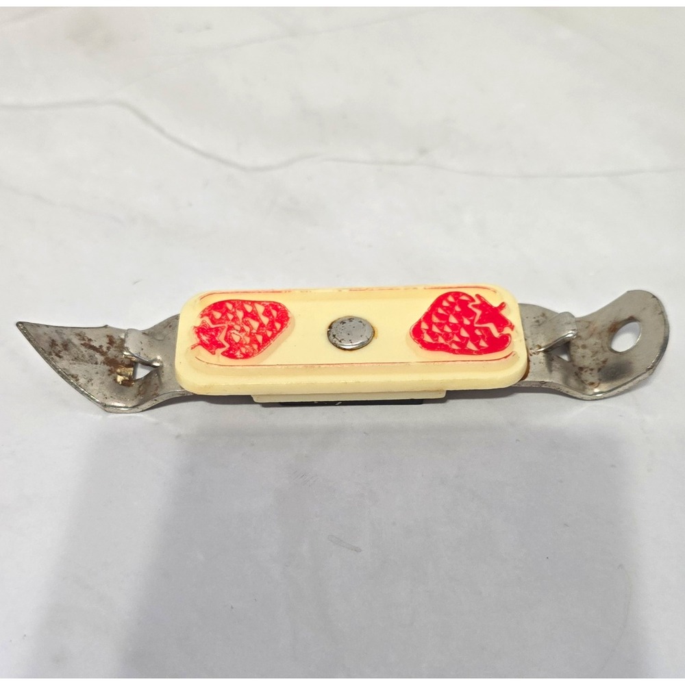 Vintage Bottle Opener With Strawberry Design and has a magnet for easy access.